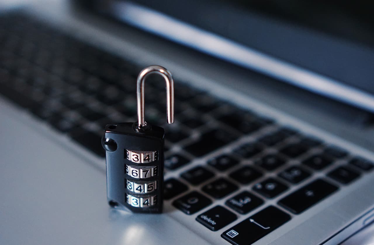 A metal padlock resting on a laptop keyboard